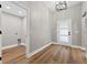 Bright entryway with wood-look floors, neutral paint, and views of the laundry room at 201 Hillside Ave, Umatilla, FL 32784