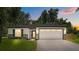 Charming home featuring stone accents, lush lawn, and a modern design on a sunny day at 201 Hillside Ave, Umatilla, FL 32784