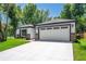 Home exterior with a bright white garage door and complementary stone accents at 201 Hillside Ave, Umatilla, FL 32784