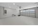 Spacious garage with epoxy floor, recessed lighting, and an automatic garage door opener at 201 Hillside Ave, Umatilla, FL 32784