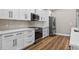 Modern kitchen features stainless steel appliances, sleek countertops, and hardwood floors at 201 Hillside Ave, Umatilla, FL 32784