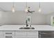 Spacious kitchen island with elegant pendant lighting and a stainless steel sink at 201 Hillside Ave, Umatilla, FL 32784
