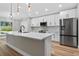 Modern kitchen featuring white cabinets, stainless steel appliances, and a center island at 201 Hillside Ave, Umatilla, FL 32784