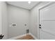 Unfurnished laundry room showcasing wood-look flooring and neutral paint at 201 Hillside Ave, Umatilla, FL 32784