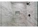 Close-up view of the new shower featuring marble tile surround and black fixtures at 201 Hillside Ave, Umatilla, FL 32784
