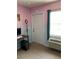 The bedroom features a pink and blue wall, a window with a fan, and an AC unit at 206 Orchid Dr, Davenport, FL 33897