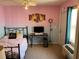 Comfortable bedroom featuring pink and blue walls, a desk, and ample natural light at 206 Orchid Dr, Davenport, FL 33897