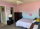 Cozy bedroom featuring a ceiling fan, two-toned walls, and a comfortable bed setup at 206 Orchid Dr, Davenport, FL 33897