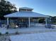 Open-air cabana with picnic tables and built-in bar, perfect for outdoor entertaining and socializing at 206 Orchid Dr, Davenport, FL 33897