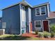 Two-story home featuring a freshly painted exterior and well-manicured landscaping at 206 Orchid Dr, Davenport, FL 33897