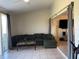 Cozy living room features tile flooring and sliding glass doors for natural light at 206 Orchid Dr, Davenport, FL 33897