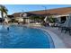 Large outdoor pool surrounded by lounge chairs and tables for relaxing and socializing at 206 Orchid Dr, Davenport, FL 33897
