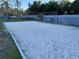 Outdoor sand volleyball court surrounded by lush green landscaping, perfect for recreation at 206 Orchid Dr, Davenport, FL 33897