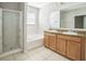 Bright bathroom featuring double sink vanity, soaking tub, and glass-enclosed shower at 236 Savannah Preserve Loop, Davenport, FL 33837