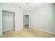 A carpeted bedroom featuring an open closet, entry door, and electrical outlets at 236 Savannah Preserve Loop, Davenport, FL 33837