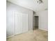 A carpeted bedroom showcasing closet and entry doors, plus baseboard electrical outlets at 236 Savannah Preserve Loop, Davenport, FL 33837