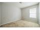 A carpeted bedroom with a window providing natural light and an electrical outlet at the baseboard at 236 Savannah Preserve Loop, Davenport, FL 33837