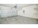 Spacious garage with concrete floor and metal door at 236 Savannah Preserve Loop, Davenport, FL 33837