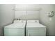 Bright laundry room featuring a side-by-side washer and dryer for convenient chores at 236 Savannah Preserve Loop, Davenport, FL 33837