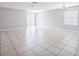 Expansive living room featuring tile flooring, natural light, and an overhead chandelier at 236 Savannah Preserve Loop, Davenport, FL 33837