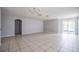 Spacious living room with tile floors and an arched entryway at 236 Savannah Preserve Loop, Davenport, FL 33837