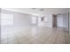 Open living room with tile floors, archway to kitchen, and an abundance of natural light at 236 Savannah Preserve Loop, Davenport, FL 33837