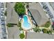 Aerial view of a community pool surrounded by residential buildings and parking at 2423 Branch Way # 207, Maitland, FL 32751
