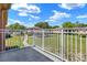 View from balcony overlooking landscaped common area with mature trees at 2423 Branch Way # 207, Maitland, FL 32751