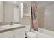 Bathroom featuring a bathtub and shower with tile surround, toilet, vanity, and mirrored medicine cabinet at 2423 Branch Way # 207, Maitland, FL 32751