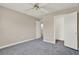 Comfortable bedroom features carpet, ceiling fan, and access to a closet and bathroom at 2423 Branch Way # 207, Maitland, FL 32751
