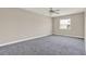 Neutral bedroom with a ceiling fan and natural light from the window at 2423 Branch Way # 207, Maitland, FL 32751