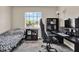 Bedroom with carpet and window, furnished with a bed, desk, and gaming computer setup at 2423 Branch Way # 207, Maitland, FL 32751