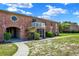 Brick condo with a balcony, screened porch, a distinctive round window, and attractive landscaping at 2423 Branch Way # 207, Maitland, FL 32751