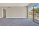 Living room with neutral walls, carpet, and slider to patio for bright, open feel at 2423 Branch Way # 207, Maitland, FL 32751
