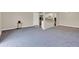 Open-concept living space with new carpet, neutral walls, and access to the kitchen at 2423 Branch Way # 207, Maitland, FL 32751
