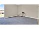 Bright living room with neutral walls, new carpet, and a view of the balcony through the sliding glass door at 2423 Branch Way # 207, Maitland, FL 32751