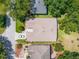 Aerial view showcasing the home's roof, landscaping, driveway, and surrounding neighborhood at 25243 River Crest Dr, Leesburg, FL 34748