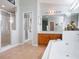 Bright bathroom featuring a walk-in shower, soaking tub, and double vanity with wood cabinetry at 25243 River Crest Dr, Leesburg, FL 34748