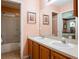 Bathroom features a double vanity, a toilet, a shower, and two mirrors at 25243 River Crest Dr, Leesburg, FL 34748