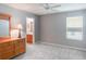 Bedroom with light grey walls, hardwood floor, and a large wooden dresser at 25243 River Crest Dr, Leesburg, FL 34748
