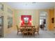 Elegant dining area featuring a wood table, bright walls, and ample lighting, perfect for Gathering gatherings at 25243 River Crest Dr, Leesburg, FL 34748