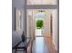Inviting foyer with light blue walls, wood floors, and an open view to the outdoors through a glass front door at 25243 River Crest Dr, Leesburg, FL 34748