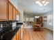 Open kitchen with wooden cabinets, granite countertops, and a breakfast nook at 25243 River Crest Dr, Leesburg, FL 34748