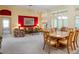Open-concept living and dining area with large windows, modern lighting, and neutral carpet, perfect for entertaining at 25243 River Crest Dr, Leesburg, FL 34748