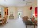 Spacious living room with bright walls, plush carpet, and elegant furniture, creating a cozy and inviting atmosphere at 25243 River Crest Dr, Leesburg, FL 34748