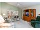 Cozy living room featuring a large television, couches, and a fan at 25243 River Crest Dr, Leesburg, FL 34748