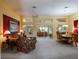 Spacious living area with open layout, bright lighting, and access to outdoor views through expansive windows at 25243 River Crest Dr, Leesburg, FL 34748