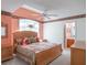 Spacious primary bedroom with a ceiling fan, comfortable bed, and ensuite bathroom at 25243 River Crest Dr, Leesburg, FL 34748