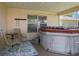 Cozy covered patio with a hot tub, seating area, and relaxing ambiance at 25243 River Crest Dr, Leesburg, FL 34748