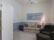 Cozy sitting area with soft lighting, plush seating, and neutral tones, ideal for relaxation and comfort at 25243 River Crest Dr, Leesburg, FL 34748